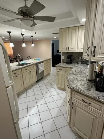 a kitchen with a table chairs and refrigerator