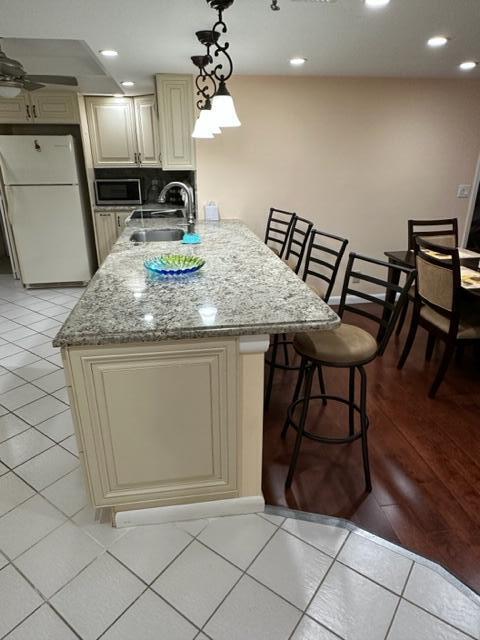 6500 Northwest 2nd Avenue, Unit 512 Boca Raton, FL 33487 - Photo 8 of 41 a kitchen with a table chairs and refrigerator