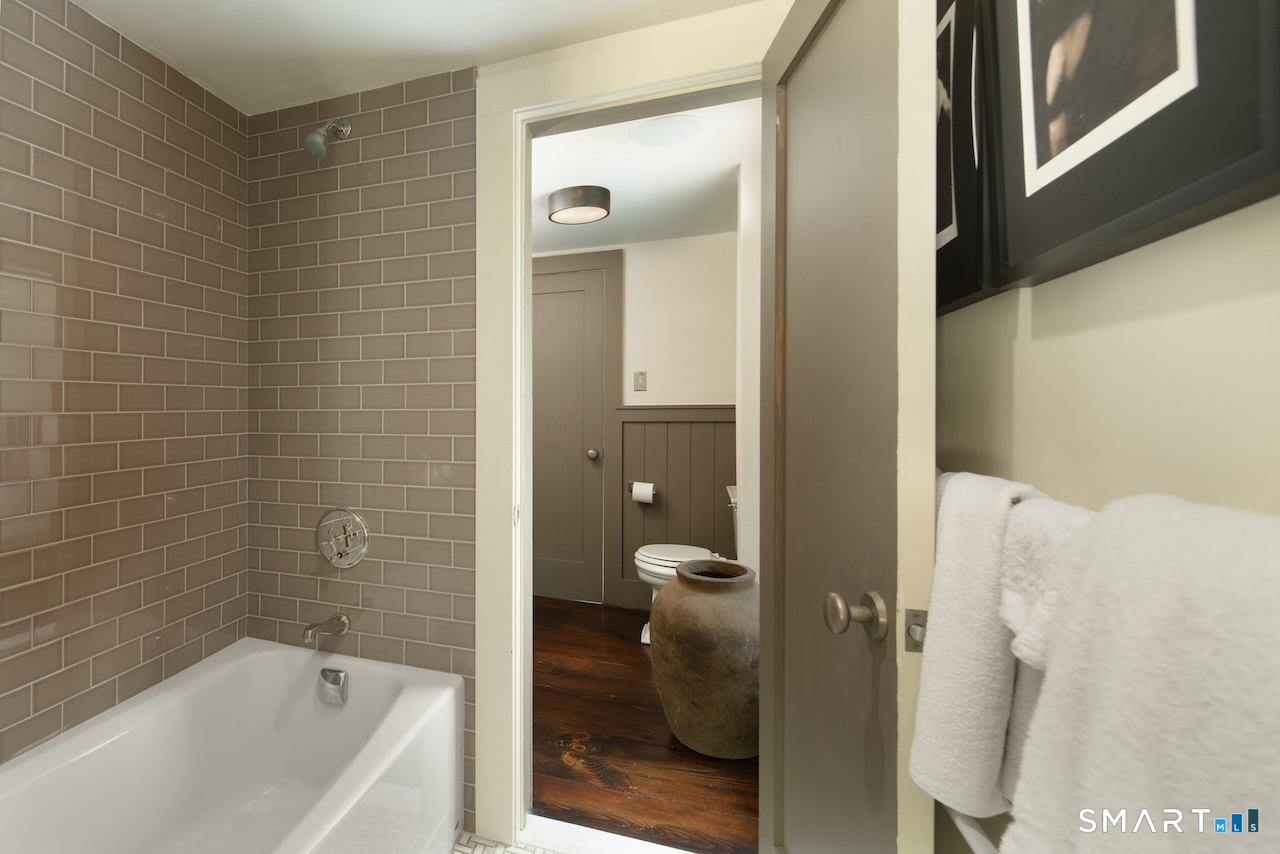 329 Housatonic River Road Salisbury, CT 06031 - Photo 17 of 32 a bathroom with a bathtub and a shower