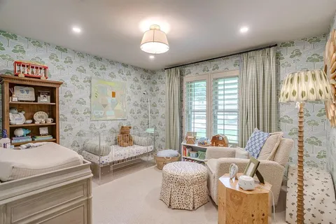 a bedroom with furniture and a large window