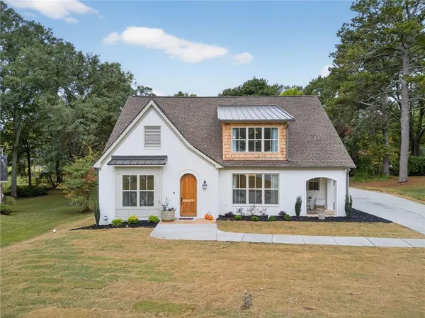 a front view of a house with garden