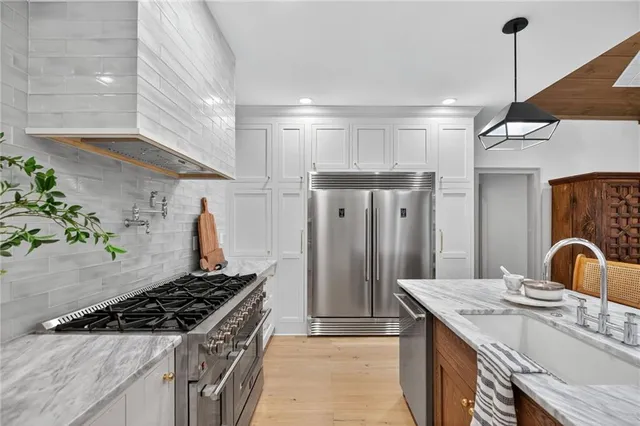 a kitchen with a stove and potted plant