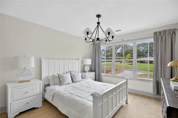 a bedroom with 2 bed table and a window