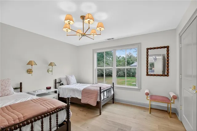 a backyard of a house with table and chairs under an umbrella