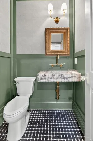 a bathroom with a sink a toilet and mirror