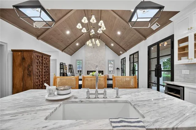 a view of a dining room with furniture a chandelier and wooden floor
