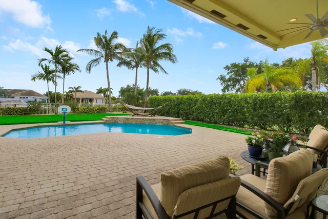 a view of a backyard and swimming pool