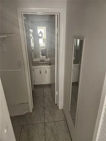 a view of a livingroom with wooden floor and a sink