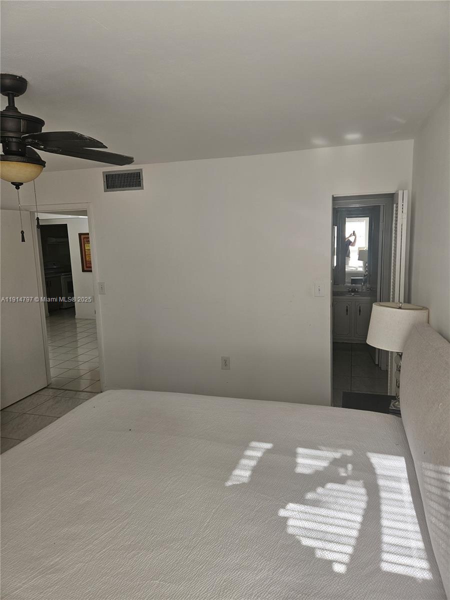 201 178th Drive, Unit 302 Sunny Isles Beach, FL 33160 - Photo 12 of 19 a view of a livingroom with wooden floor and a sink