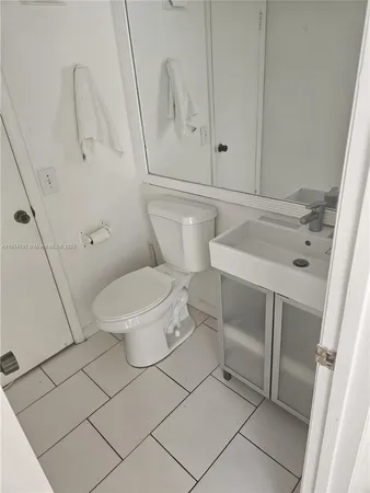 a bathroom with a glass door shower and a sink