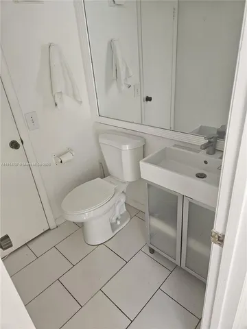 a bathroom with a glass door shower and a sink