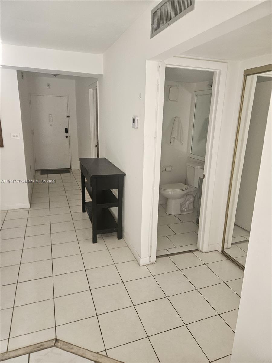 201 178th Drive, Unit 302 Sunny Isles Beach, FL 33160 - Photo 15 of 19 a bathroom with a glass door shower and a sink