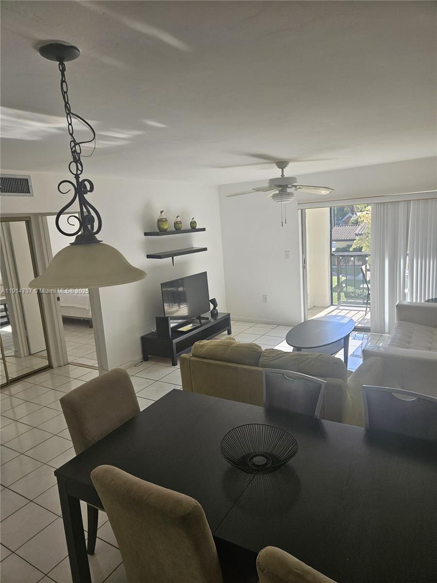 201 178th Drive, Unit 302 Sunny Isles Beach, FL 33160 - Photo 16 of 19 a living room with furniture and a chandelier