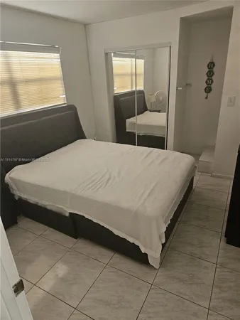 a living room with furniture and a mirror