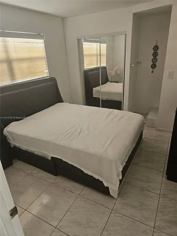 a living room with furniture and a mirror