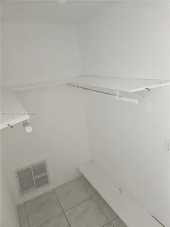 a white toilet sitting next to a shower