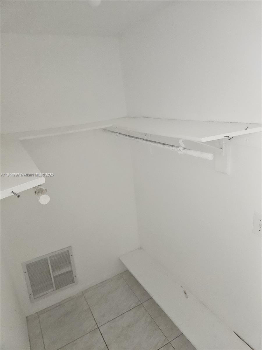 201 178th Drive, Unit 302 Sunny Isles Beach, FL 33160 - Photo 9 of 19 a view of an empty walk in closet