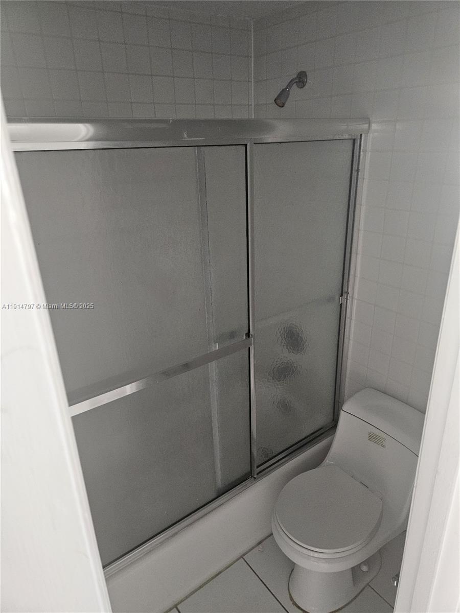 201 178th Drive, Unit 302 Sunny Isles Beach, FL 33160 - Photo 10 of 19 a white toilet sitting next to a shower
