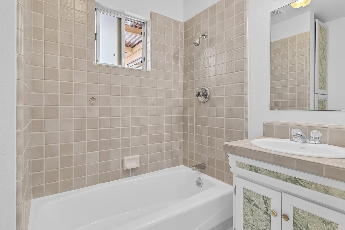 1021 Wheeler Street Seaside, CA 93955 - Photo 13 of 28 a white bath tub sitting next to a white sink