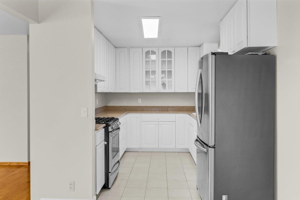1021 Wheeler Street Seaside, CA 93955 - Photo 7 of 28 a kitchen with a refrigerator and a sink