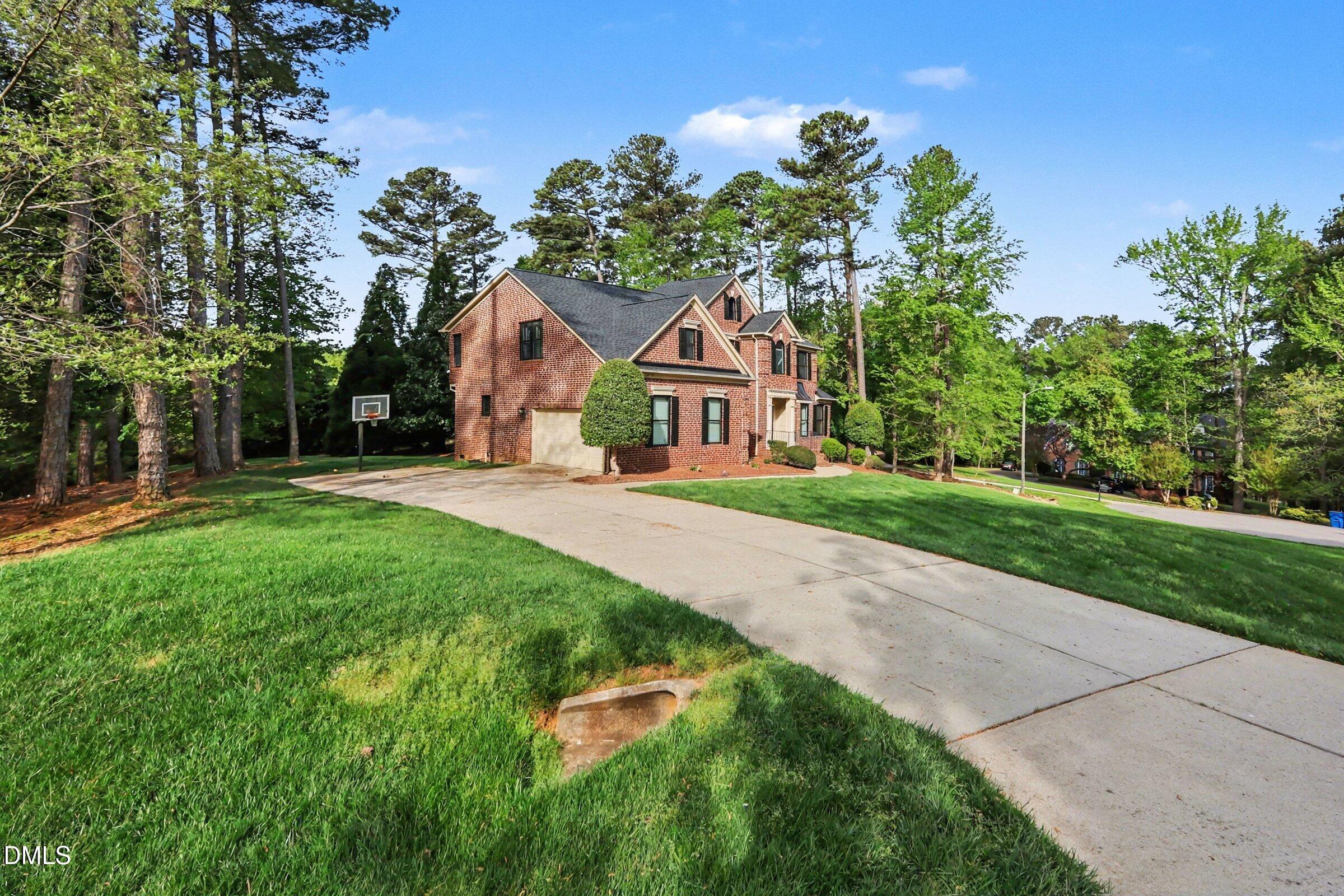 1001 Denfield Court Raleigh, NC 27615 - Photo 35 of 44 a front view of a house with a yard and trees