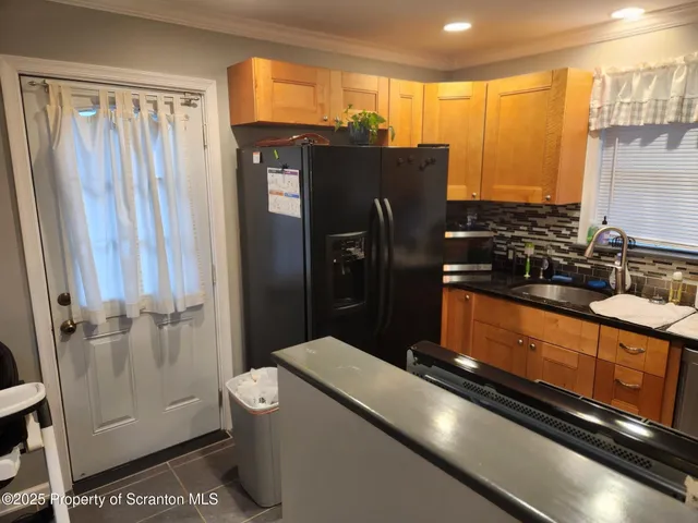 a kitchen with a sink and a refrigerator