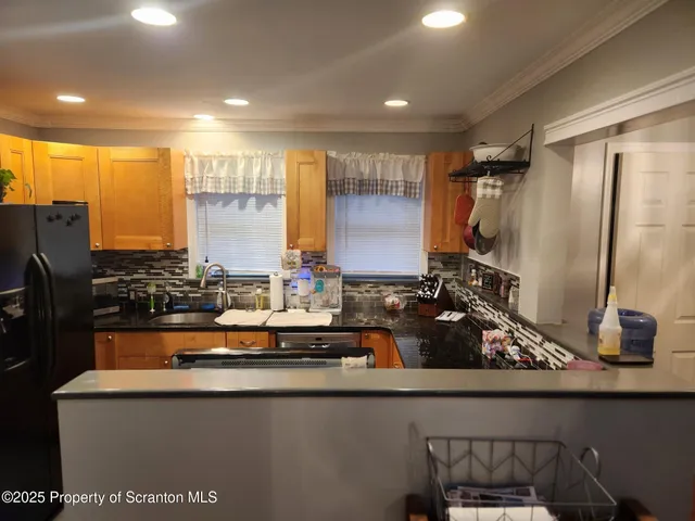 a kitchen with sink a stove and cabinets
