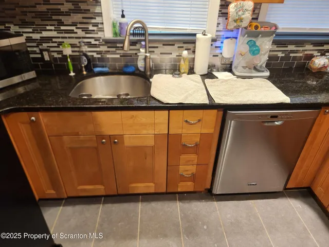 a white toilet sitting next to a bathroom sink and a shower
