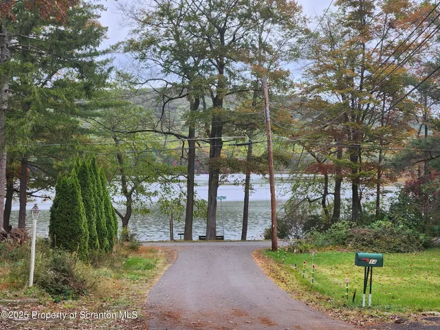 a view of a hallway with wooden floor and door