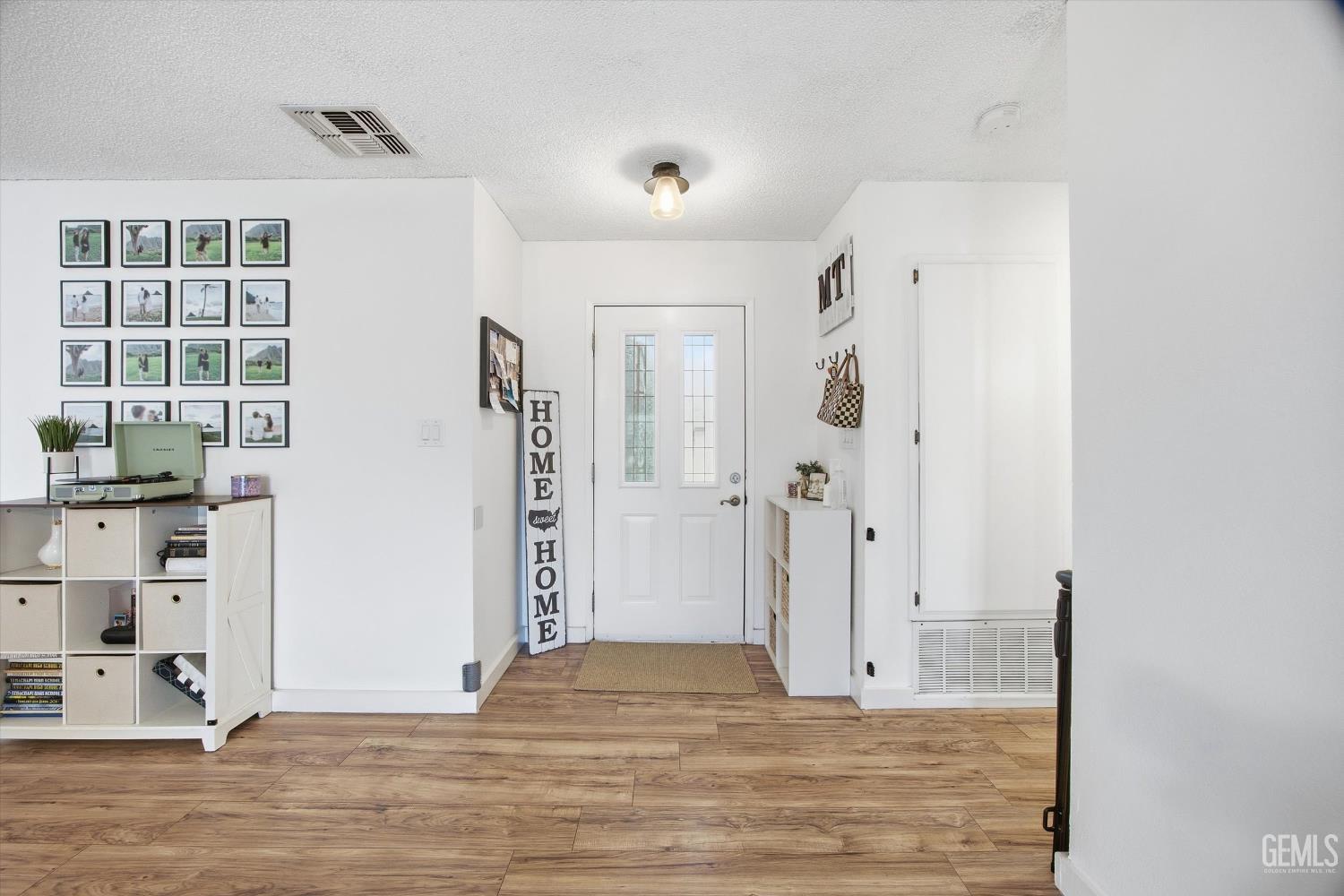 Undisclosed Address Tehachapi, CA 93561 - Photo 11 of 46 a view of a livingroom with wooden floor and a window