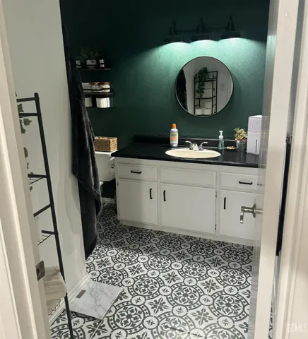 a bathroom with a sink mirror vanity and toilet