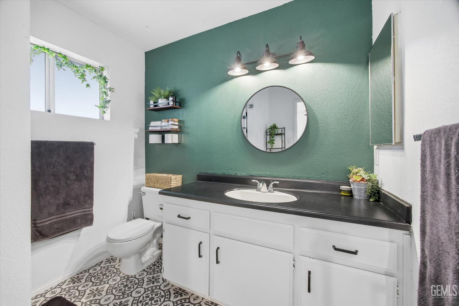 Undisclosed Address Tehachapi, CA 93561 - Photo 21 of 46 a bathroom with a toilet sink and mirror