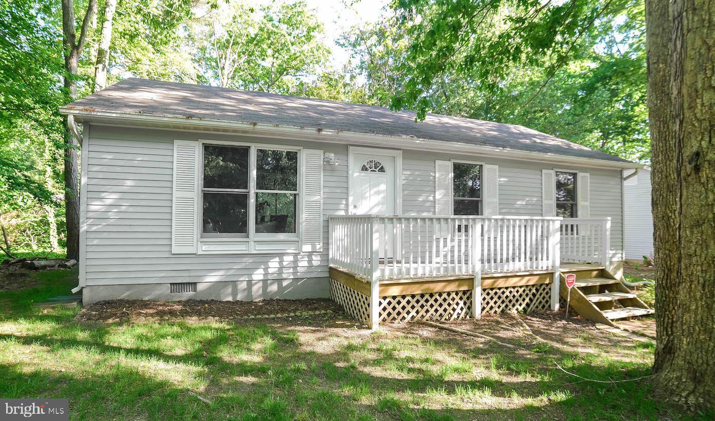 12788 Rio Grande Trail Lusby, MD 20657 - Photo 1 of 29 a view of a house with a small yard and a large tree