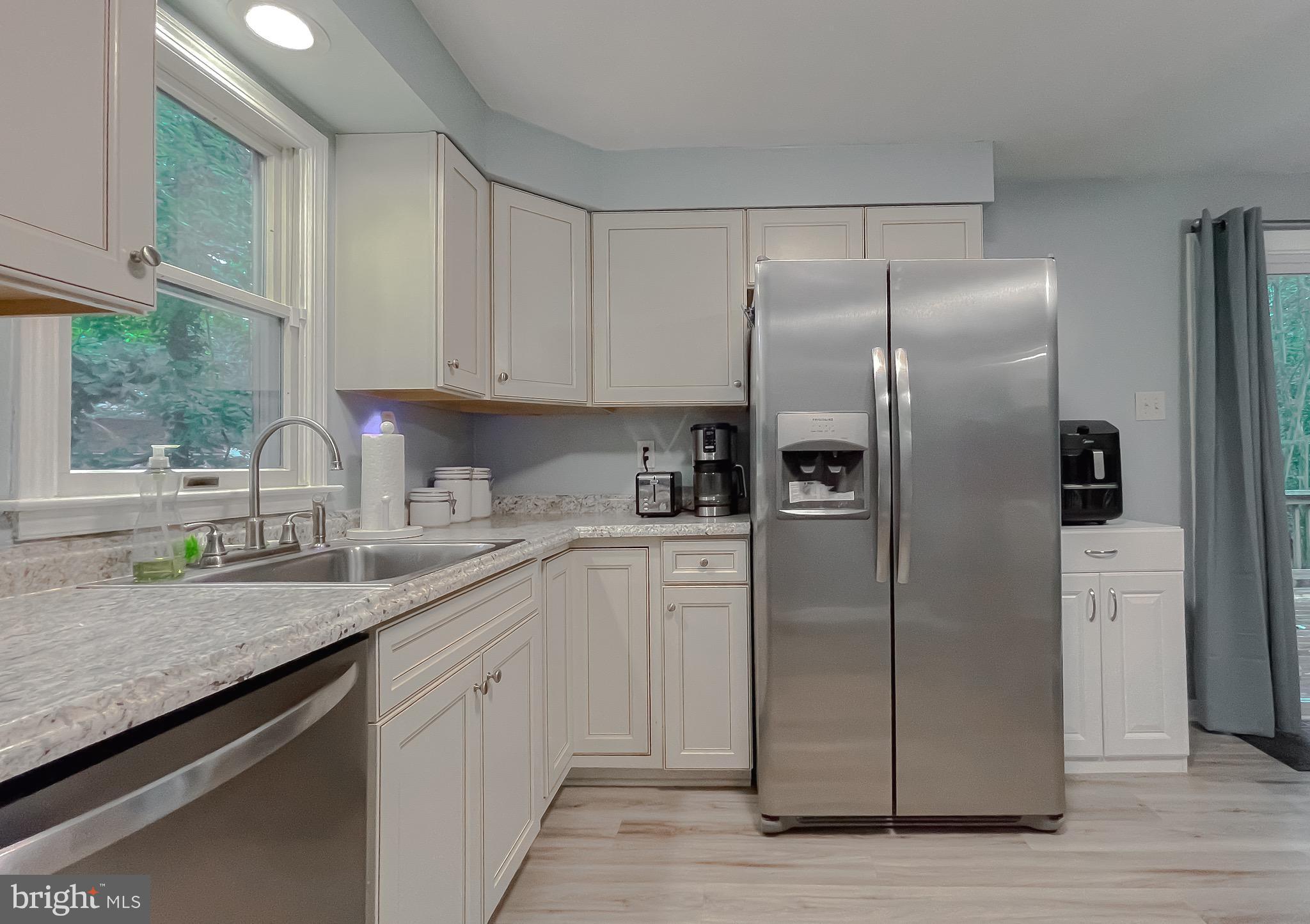 12788 Rio Grande Trail Lusby, MD 20657 - Photo 12 of 29 a kitchen with stainless steel appliances granite countertop a refrigerator a sink and white cabinets