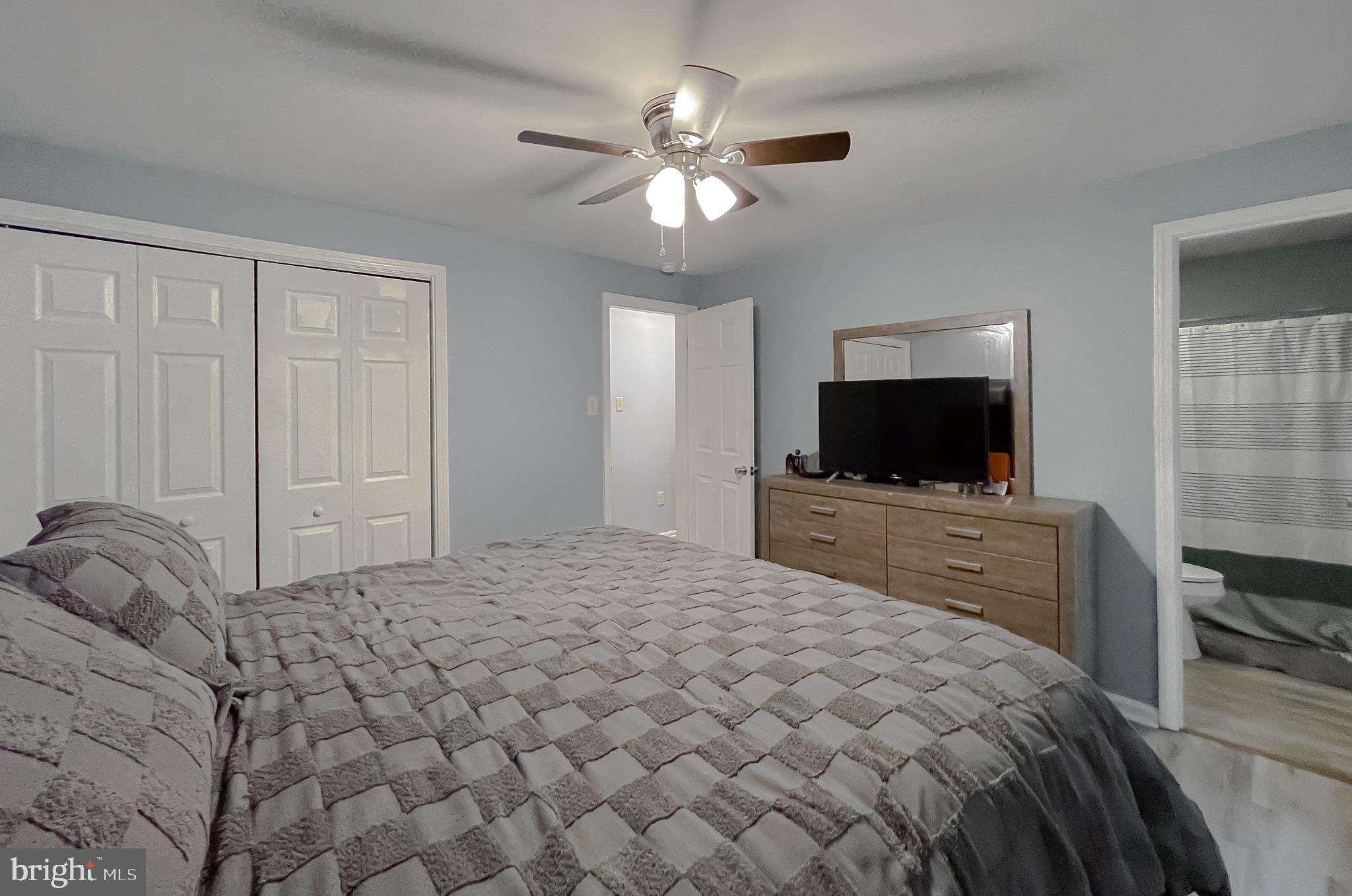 12788 Rio Grande Trail Lusby, MD 20657 - Photo 21 of 29 a bedroom with a bed and a flat screen tv