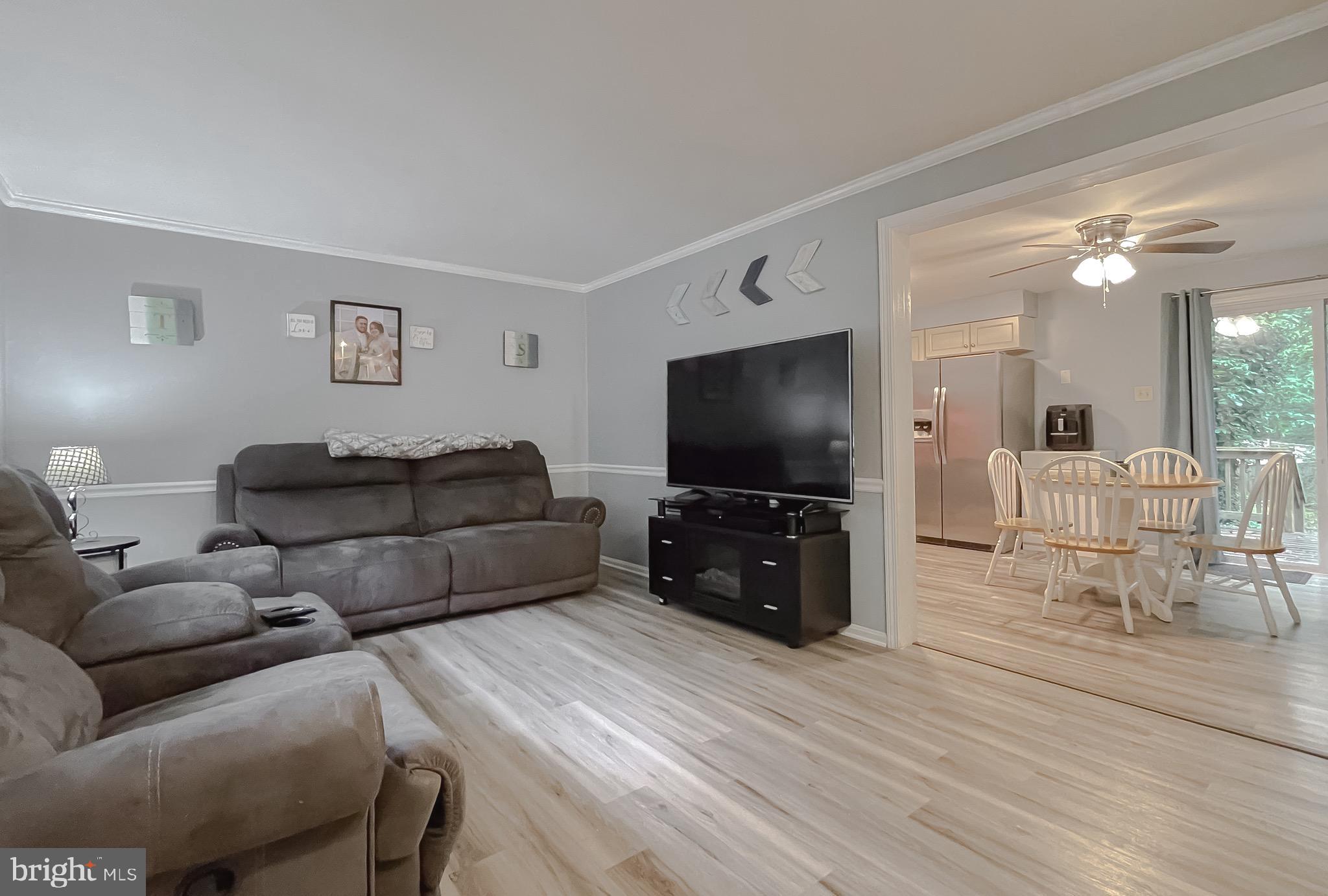 12788 Rio Grande Trail Lusby, MD 20657 - Photo 5 of 29 a living room with furniture and a flat screen tv