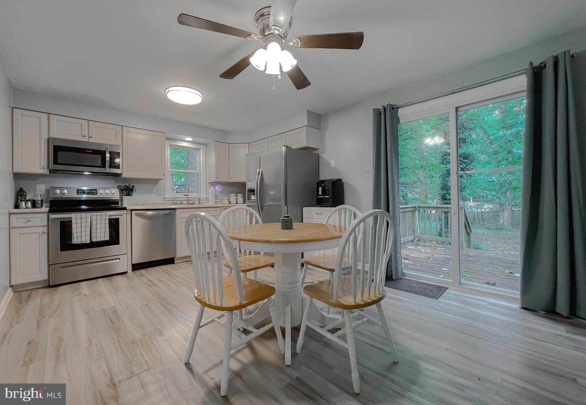 12788 Rio Grande Trail Lusby, MD 20657 - Photo 10 of 29 a view of a dining room with furniture window and wooden floor