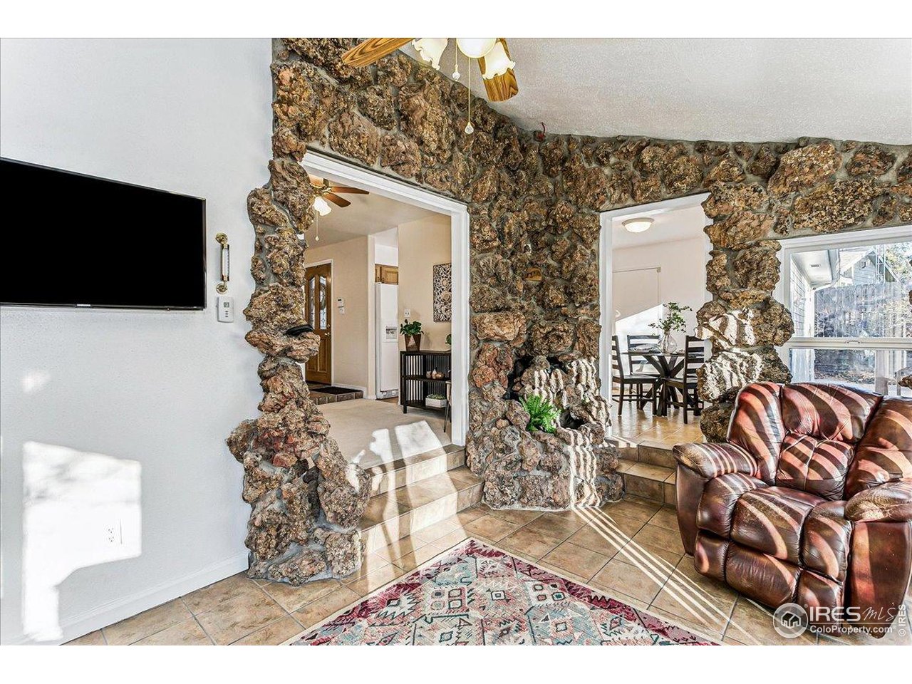 1725 Ridgewood Road Fort Collins, CO 80526 - Photo 14 of 46 Sunroom features a rock wall!