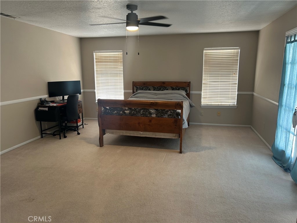 20187 Itasca Road Apple Valley, CA 92308 - Photo 14 of 35 a bedroom with a bed and a desk