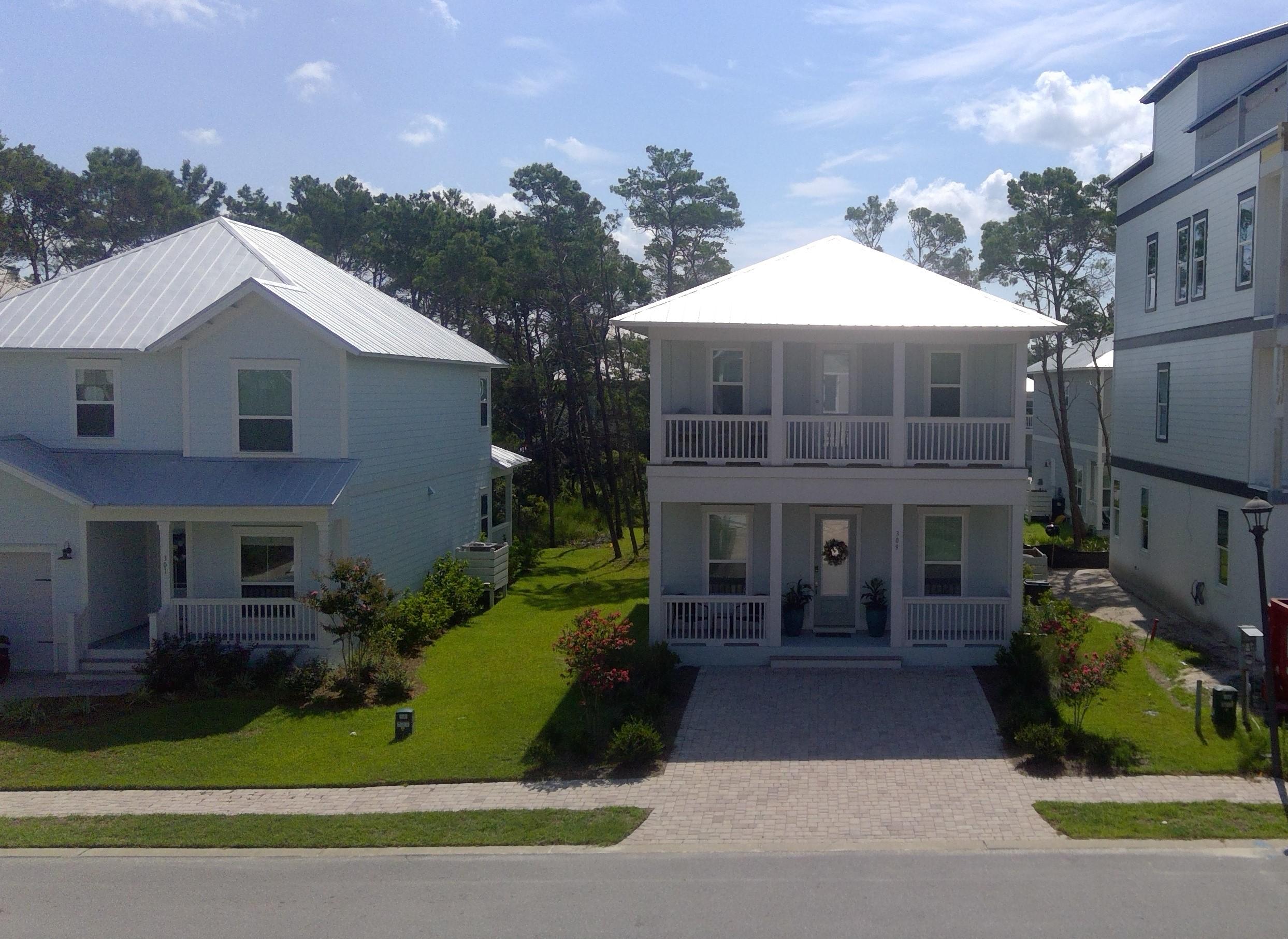 310 Grande Pointe Circle Inlet Beach, FL 32461 - Photo 2 of 63 a front view of a house with garden