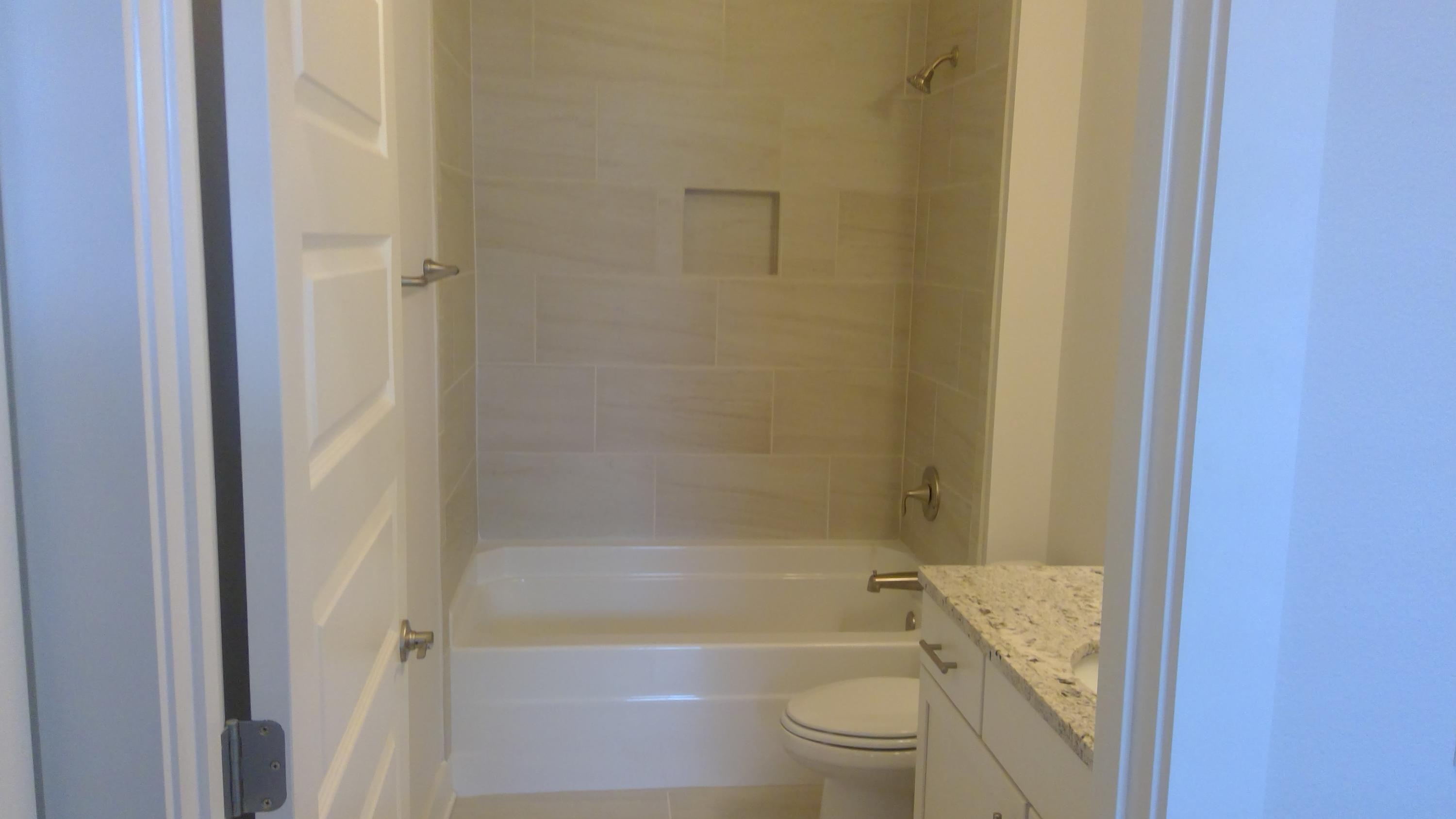 310 Grande Pointe Circle Inlet Beach, FL 32461 - Photo 28 of 63 a bathroom with a granite countertop toilet a sink and bathtub