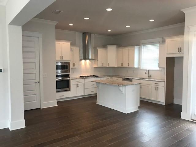 310 Grande Pointe Circle Inlet Beach, FL 32461 - Photo 4 of 63 a kitchen with granite countertop white cabinets and stainless steel appliances