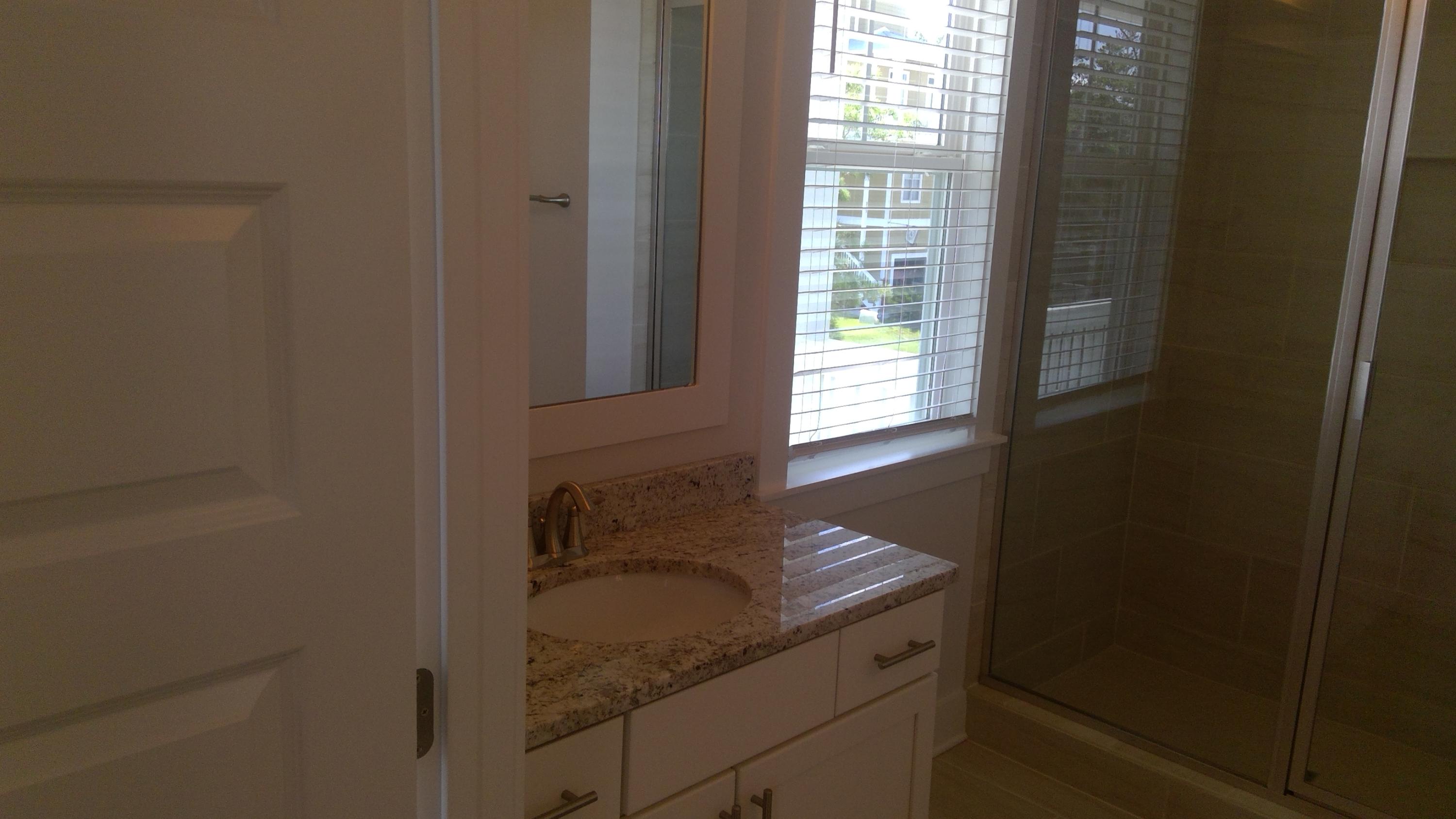 310 Grande Pointe Circle Inlet Beach, FL 32461 - Photo 34 of 63 a bathroom with a granite countertop sink and mirror next to window