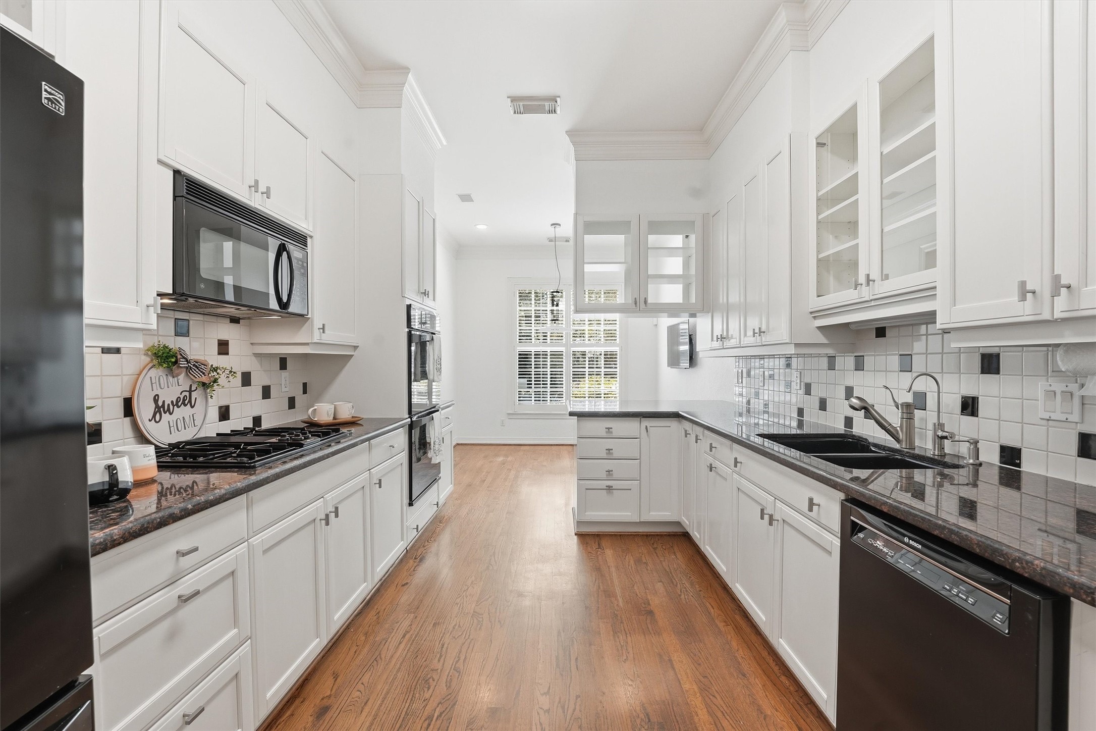3210 Maroneal Street Houston, TX 77025 - Photo 11 of 28 a large kitchen with stainless steel appliances granite countertop a lot of counter space and wooden floors