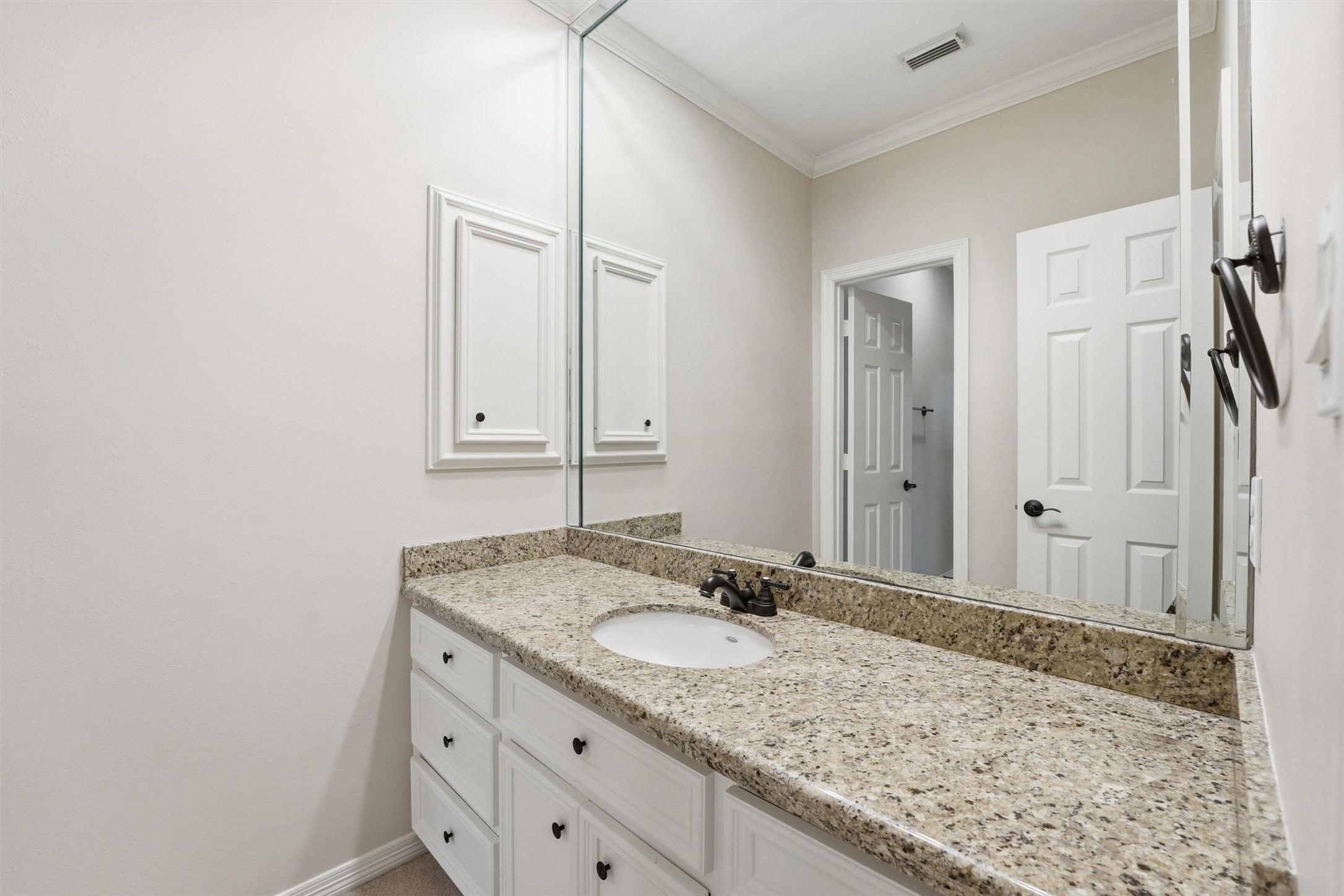 3210 Maroneal Street Houston, TX 77025 - Photo 23 of 28 a bathroom with a granite countertop sink and a mirror