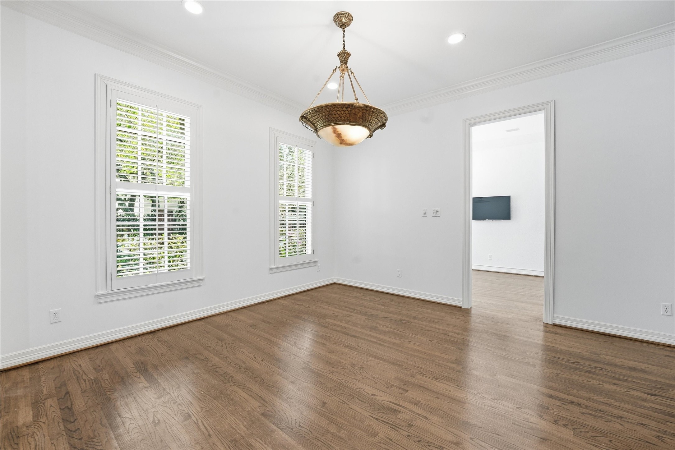 3210 Maroneal Street Houston, TX 77025 - Photo 6 of 28 an empty room with wooden floor and windows