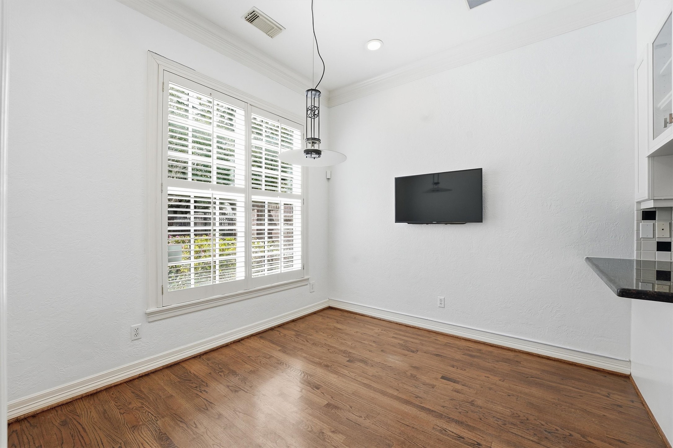 3210 Maroneal Street Houston, TX 77025 - Photo 7 of 28 a view of an empty room with wooden floor and a window