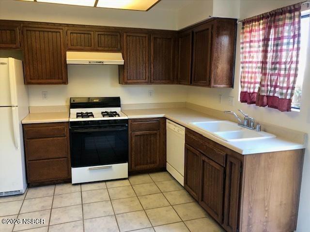 208 North R Street Lompoc, CA 93436 - Photo 5 of 22 a kitchen with a stove sink and cabinets