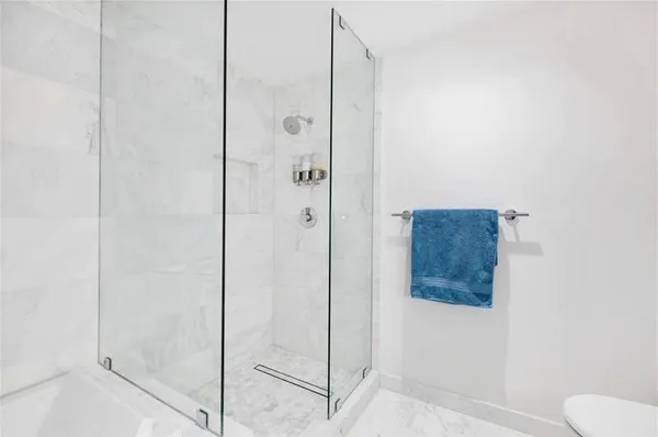 a bathroom with a sink toilet vanity and shower