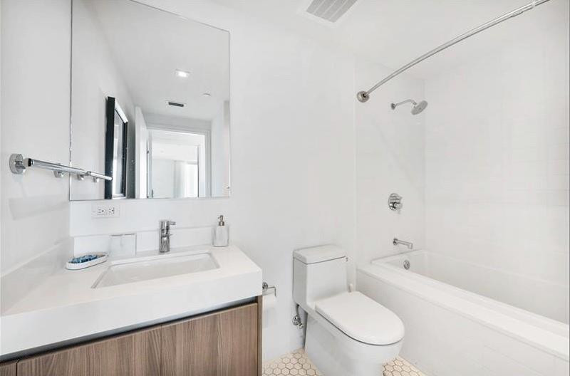 401 North Birch Road, Unit 515 Fort Lauderdale, FL 33304 - Photo 23 of 23 a bathroom with a sink toilet vanity and shower